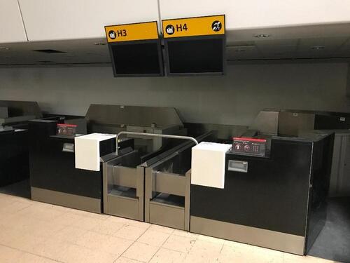 A pair of check in desks with Avery Weigh-Tronix scales