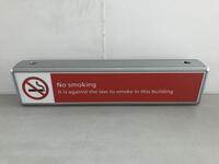 Illuminated 'No Smoking' sign, curved metal construction.