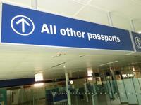 Illuminated 'All other passports' sign, metal construction