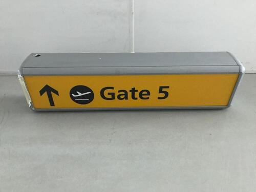 Illuminated sign 'Gate 5', curved metal construction.