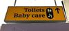 Illuminated 'Toilets Baby care' sign