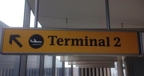 Terminal 2' ceiling mounted illuminated sign, curved metal construction
