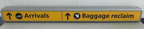 Illuminated sign 'Arrivals/Baggage reclaim, curved metal construction.