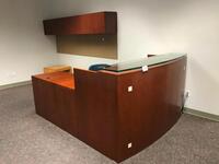 L-Shaped Reception Desk with Overhead Storage Cabinets and table. Sale is subject to seller confirmation. Location: Administrative Area