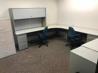 L-Shaped Desk with two (2) chairs and two (2) file cabinets. Sale is subject to seller confirmation. Location: Administrative Area