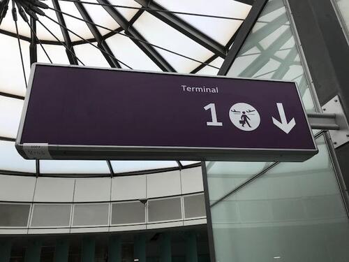 Illuminated 'Terminal 1' purple sign and hidden bonus sign