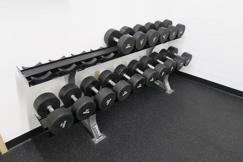 SET OF INTEK DUMB BELLS ON A HAMMER STRENGTH RACK, 65LB TO 100LB, 2014. , LOURDES HALL, LL FLOOR, RM WEIGHT ROOM