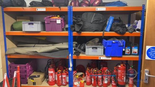 Lot assorted rubber boots, fire extinguishers, sleeping bags, hard hats, vest, PVC electrical tape, tickitape, paper