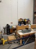 (LOT) ASSORTED SPARE PARTS, BELTS, ELECTRICAL WIRE, WHEELS, BREAKERS, SENSORS, MOTORS, LADDER, RACKS, WORK BENCH, CABINET AND DESK
