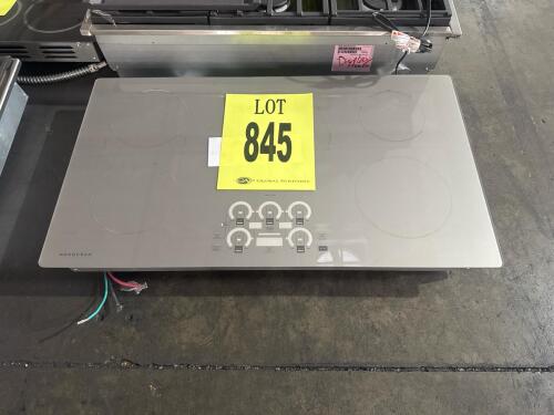 Monogram ZHU36RST1SS 36&rdquo; induction cooktop features 5 induction zones, touch controls, 11.6KW at 240V, stainless steel trim with ceramic glass surface, assembled in the USA, UL listed, FCC compliant, serial number: AV106795Q.