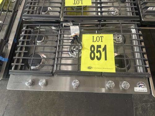 KitchenAid KCGS556ESS 36-Inch Gas Cooktop featuring 5 burners, including a powerful 20,000 BTU Professional Dual Ring Burner, electronic ignition, full-width cast-iron grates, and a CookShield finish for easy cleaning. Serial Number: DA0710520.