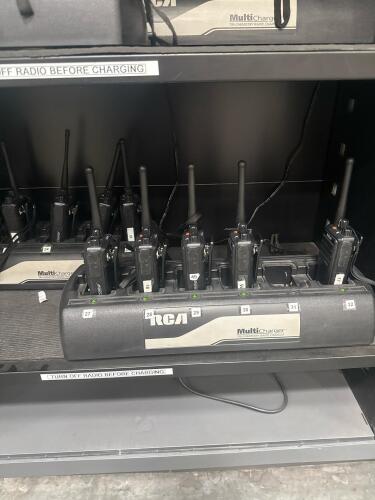 Lot (21) RCA RDR2500 PKG TWO-WAY RADIO AND (4) 6 STATION CHARGERS, (OLDER UNITS WITH BATTERIES) PLUS WALL MOUNTED ROLLING SHUTTER CABINET, 43&rdquo; L x 16&rdquo; D x 41&rdquo; H