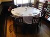 (SIZE: 4.5 FT DIAMETER) BANQUEST TABLE W/ 7 WOODEN CHAIRS - (LOCATION: 2ND FLOOR MAIN DINING AREA)