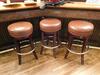 (3) LB ROUND BROWN LEATHER STOOLS (31" TALL X 16" DIAMETER) - (LOCATION: MAIN 1ST FLOOR BAR NEAR ENTRANCE)