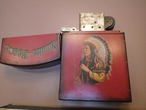 RED "SMOKE IN PEACE' NATIVE AMERICAN LIGHTER WALL PROP - (LOCATION: 1ST FLOOR CIGAR SMOKE ROOM)