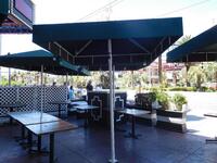 LARGE PATIO UMBRELLA (METAL BASE / FRAME) (APPROX 108" HEIGHT X 7FT WIDTH)- (LOCATION: 1ST FLOOR STRIP ENTRANCE / PATIO)