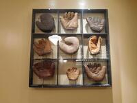 THROWBACK BASEBALL MITTS FRAMED IN A WOODEN / GLASS DISPLAY - HOLDS (9) MITTS (38" X 38") - (LOCATION: 1ST FLOOR NEAR HALLWAY)