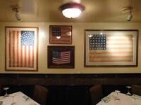 (4) FRAMED AMERICAN FLAGS (52" X 36", 42" X 31", 21" X 17", 25.5 X 21.5)- (LOCATION: 1ST FLOOR DINING ROOM NEAR CIGAR SMOKE ROOM & KITCHEN)