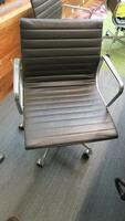 HERMAN MILLER "EAMES" ALUMINUM GROUP MANAGEMENT GROUP CHAIR, MANUAL LIFT WITH CASTERS AND ARMS, CARPET CASTERS WITH CHROME HOOD, POLISHED ALUMINUM BASE AND FRAME, BLACK MLC LEATHER. MSRP $2000