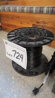 PARTIAL SPOOL OF HEAVY COPPER STRANDED GROUND WIRE IN BLACK SHEATH.