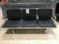 Three person seat, black leather style front and backs, 3 armrests consisting of 1 left, no middle, 2 right hand side, cast alloy construction.