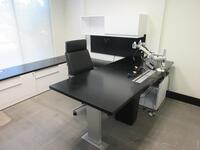 STEELCASE WOOD BLACK AND WHITE L - SHAPE DESK W/ LEFT RETURN AND POWER DISTRIBUTION UNIT 7' X 115" W/ OVER HEAD CABINET, CREDENZA 9' X 24" X 23" AND STEELCASE 30" ROUND TABLE, (2) BLACK SIDE CHAIRS AND (1) BLACK OFFICE CHAIR, (1ST FLOOR)