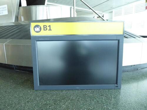 Check-in desk 'B1' sign and monitor