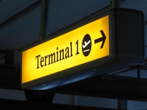Terminal 1 direction sign, illuminated. Curved metal edge construction including internal light fittings.