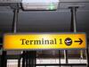 Terminal 1 direction sign, illuminated. Curved metal edge construction including internal light fittings. - 9