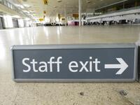 Staff exit sign, with curved edges, metal construction.