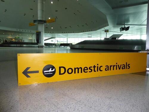 Domestic arrivals sign, metal plate construction