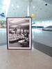 Black and white picture of passengers relaxing in airport lounge - 2
