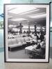 Black and white picture of passengers relaxing in airport lounge - 3