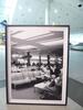 Black and white picture of passengers relaxing in airport lounge - 4